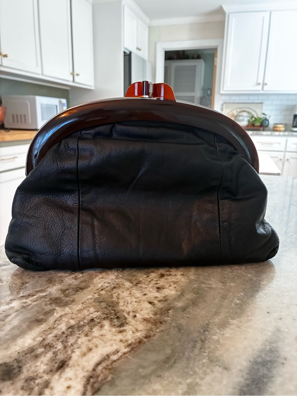 Vintage 60’s black pebbled leather clutch with brown resin mold, beautiful